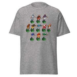 Short sleeve t-shirt with 11 retro style electric football game players printed across the front. Each player is roughly 2 inches by 3 inches and wearing different colorful uniforms. Heather gray shirt.