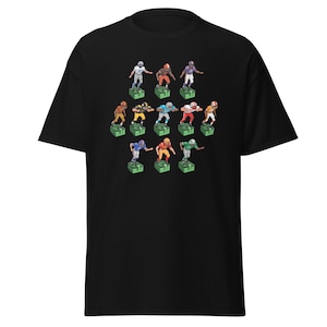 Short sleeve t-shirt with 11 retro style electric football game players printed across the front. Each player is roughly 2 inches by 3 inches and wearing different colorful uniforms. Black Shirt.