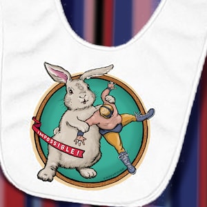 May include: White baby bib with a cartoon illustration of a large rabbit wrestling a person. The rabbit is holding the person, who is wearing a wrestling outfit. A red banner reads "IMPOSSIBLE!"