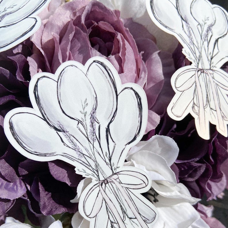 May include: A bouquet of five white crocuses tied with a ribbon, drawn in a watercolor style on a white background. The crocuses are arranged in a fan shape with the stems tied together at the base.