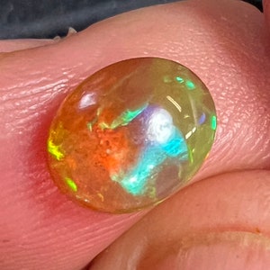Opal cabochon 1.46 Carats 7.5x9.5mm nice multicolored flash, with teals in an amber and green base.