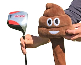 May include: A brown plush golf club head cover shaped like a smiling poop emoji. The club head cover is attached to a brown plush shaft.