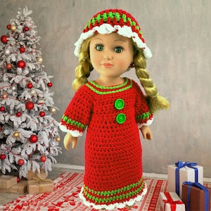 May include: A red crocheted Christmas dress with green trim and white crocheted edging. The dress has two green buttons. The doll is wearing a white crocheted hat with green and red stripes.