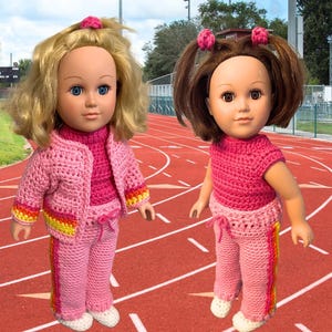 May include: Two dolls wearing pink crocheted tracksuits with yellow and orange stripes. The dolls are standing on a red running track.