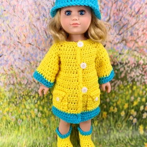 May include: A yellow crocheted raincoat with blue trim, a blue crocheted hat, and yellow crocheted rain boots for a doll.