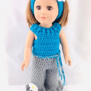 May include: A crocheted doll outfit in teal and gray with a white flower headband. The outfit includes a sleeveless top and flared pants with a white flower accent.