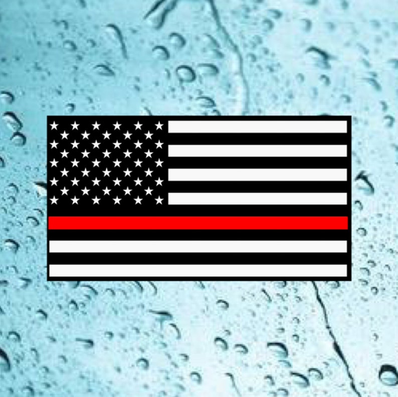 May include: An American flag with a thin red stripe across the middle, representing the thin red line of firefighters.