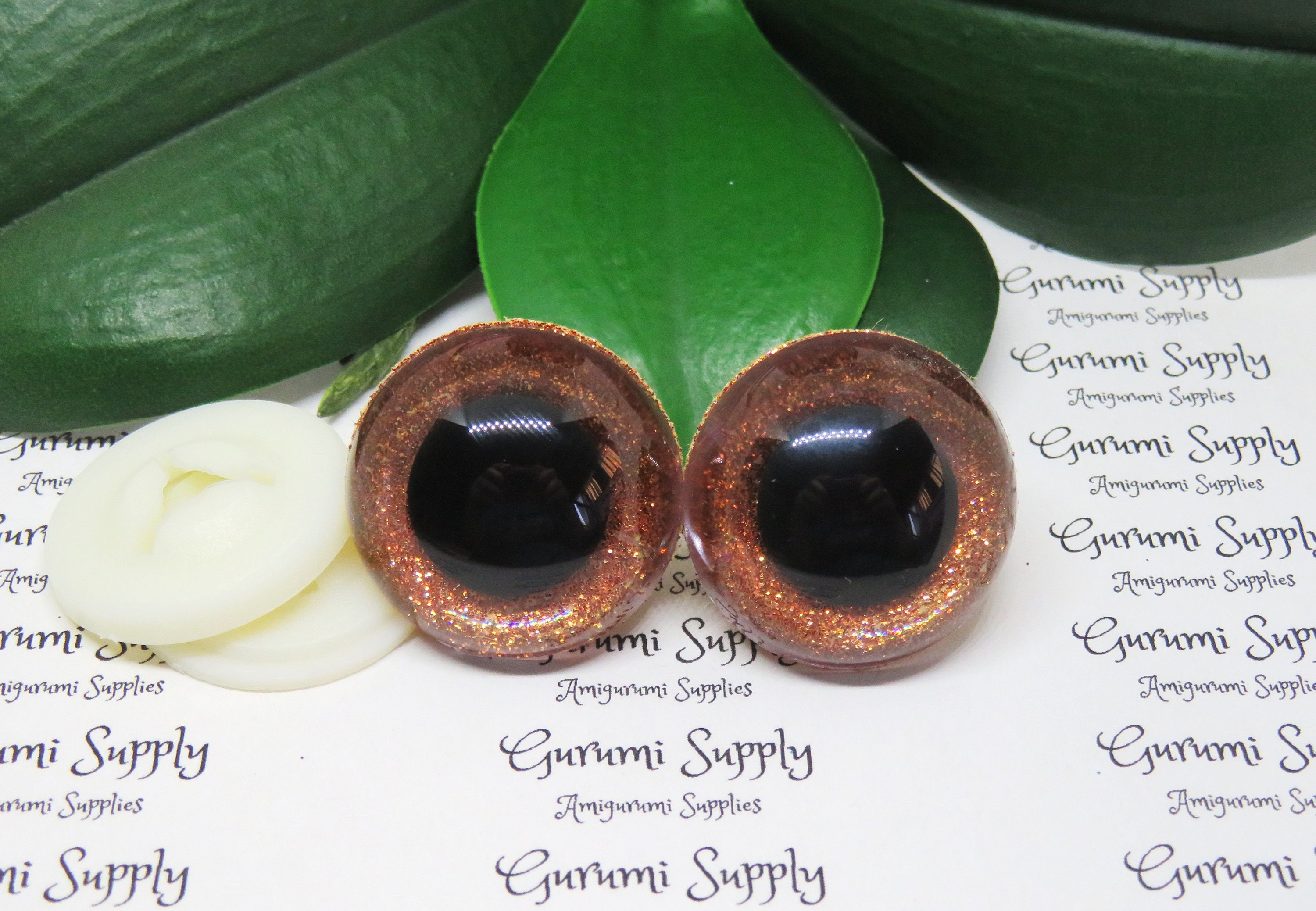 30mm Clear Safety Eyes with an Orange Glitter Slip and Black Iris