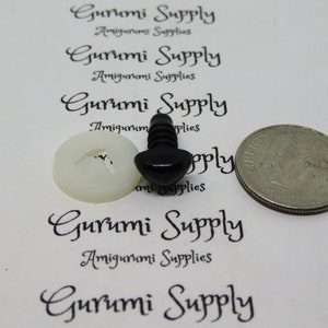 May include: Black plastic safety eyes for amigurumi projects, with a white plastic washer. The eyes are shown next to a US quarter for size comparison.