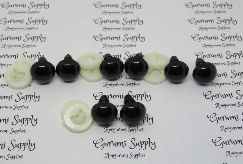 May include: A set of black plastic safety eyes with white plastic washers. The eyes are approximately 12 mm in diameter.