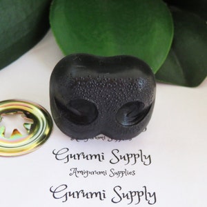 May include: Black plastic safety eyes for amigurumi projects. The eyes have a textured surface and are designed for sewing onto stuffed toys.
