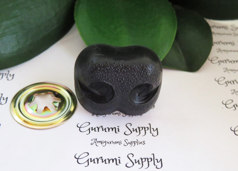 May include: Black plastic safety eyes for amigurumi projects. The eyes have a textured surface and are designed for sewing onto stuffed toys.