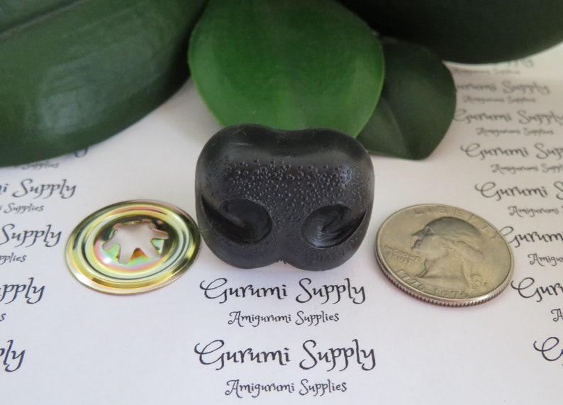 May include: Black plastic amigurumi safety eyes with a shiny gold metal washer. The eyes are about 1 inch in diameter.