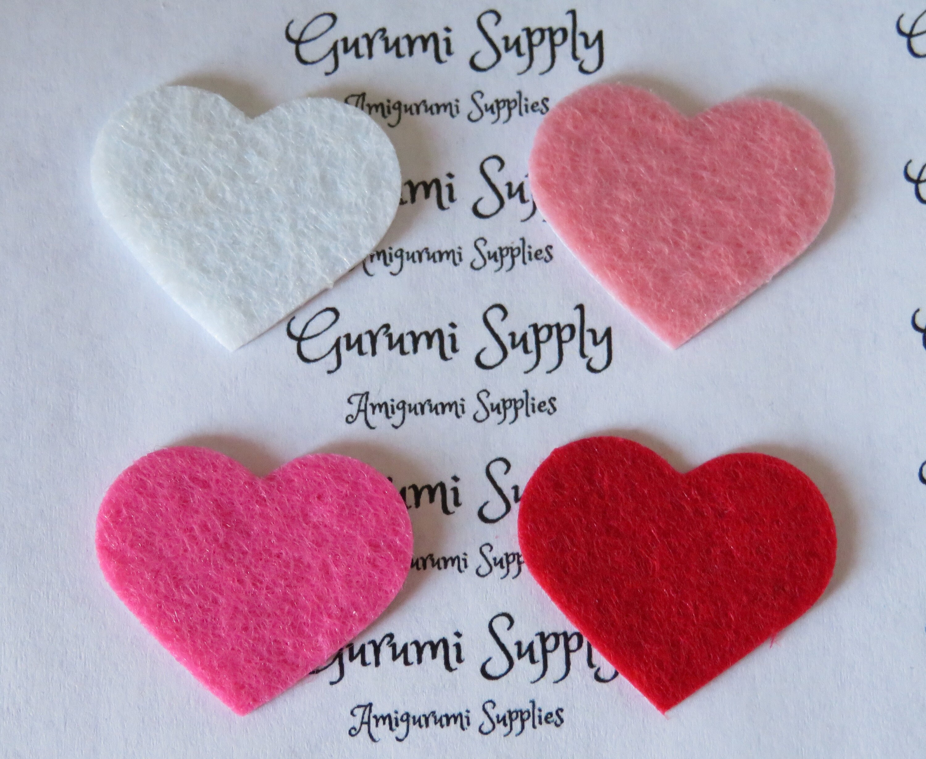 1 inch white heart shape felt cut outs with a sticker backing 1 color