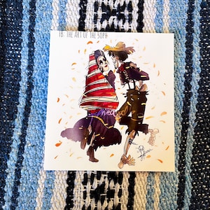 May include: A colorful illustration of two skeletons dancing. The skeleton on the left is wearing a red and white striped dress and a black shawl. The skeleton on the right is wearing a brown hat, a black vest, and brown pants. The background is a white paper with a scattering of orange and yellow confetti.