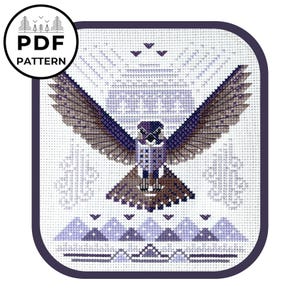 May include: A cross-stitch pattern featuring a stylized purple and brown hawk with outstretched wings against a white background with purple geometric designs. The pattern includes a mountain range at the bottom.