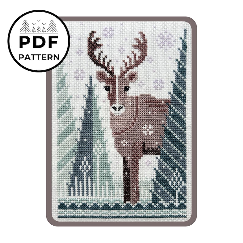 May include: A cross-stitch pattern featuring a brown reindeer with large antlers, standing in a snowy forest. The design includes snowflakes and evergreen trees in shades of blue and green. The words "PDF PATTERN" are in a circle.