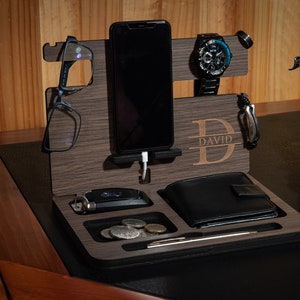 May include: A wooden desktop organizer with a phone stand, watch holder, glasses holder, wallet slot, and a key hook. The organizer is personalized with the name "DAVID".