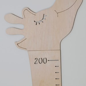 May include: Wooden giraffe height chart with a smiling face and eyelashes. The chart has markings for 190 and 200 centimeters.