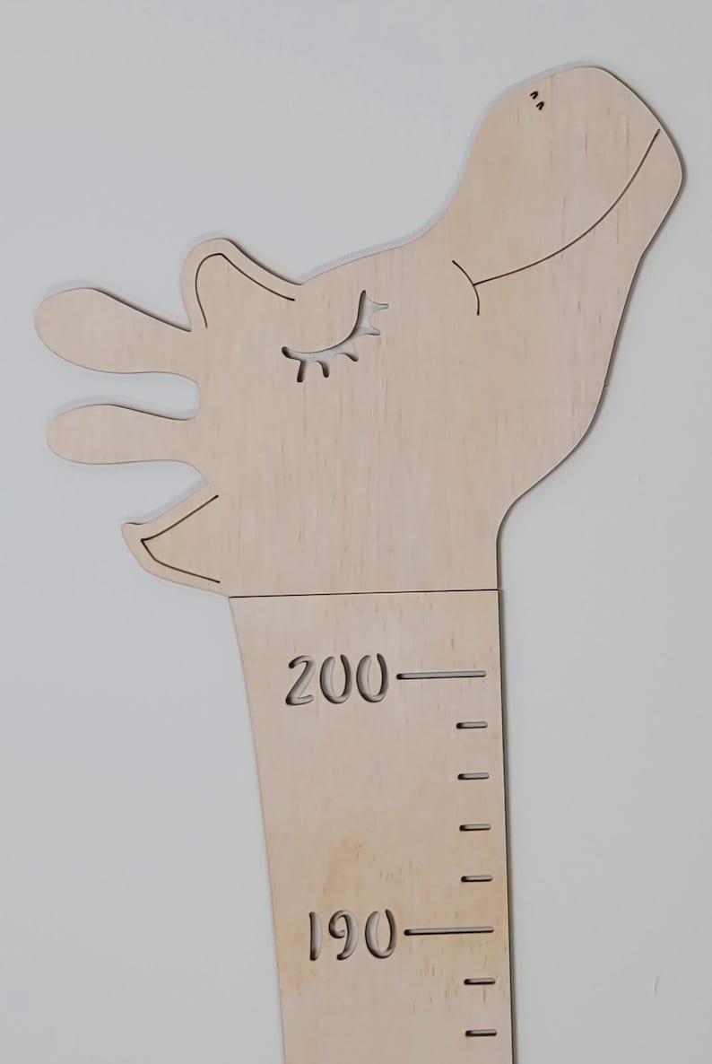 May include: Wooden giraffe height chart with a smiling face and eyelashes. The chart has markings for 190 and 200 centimeters.