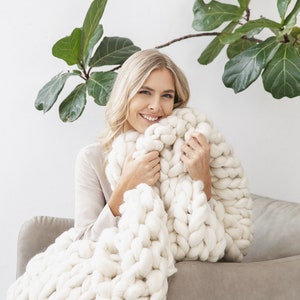 Lady happy with her chunky white merino wool blanket