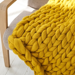 a close up Extreme giant knit blanket throw in mustard