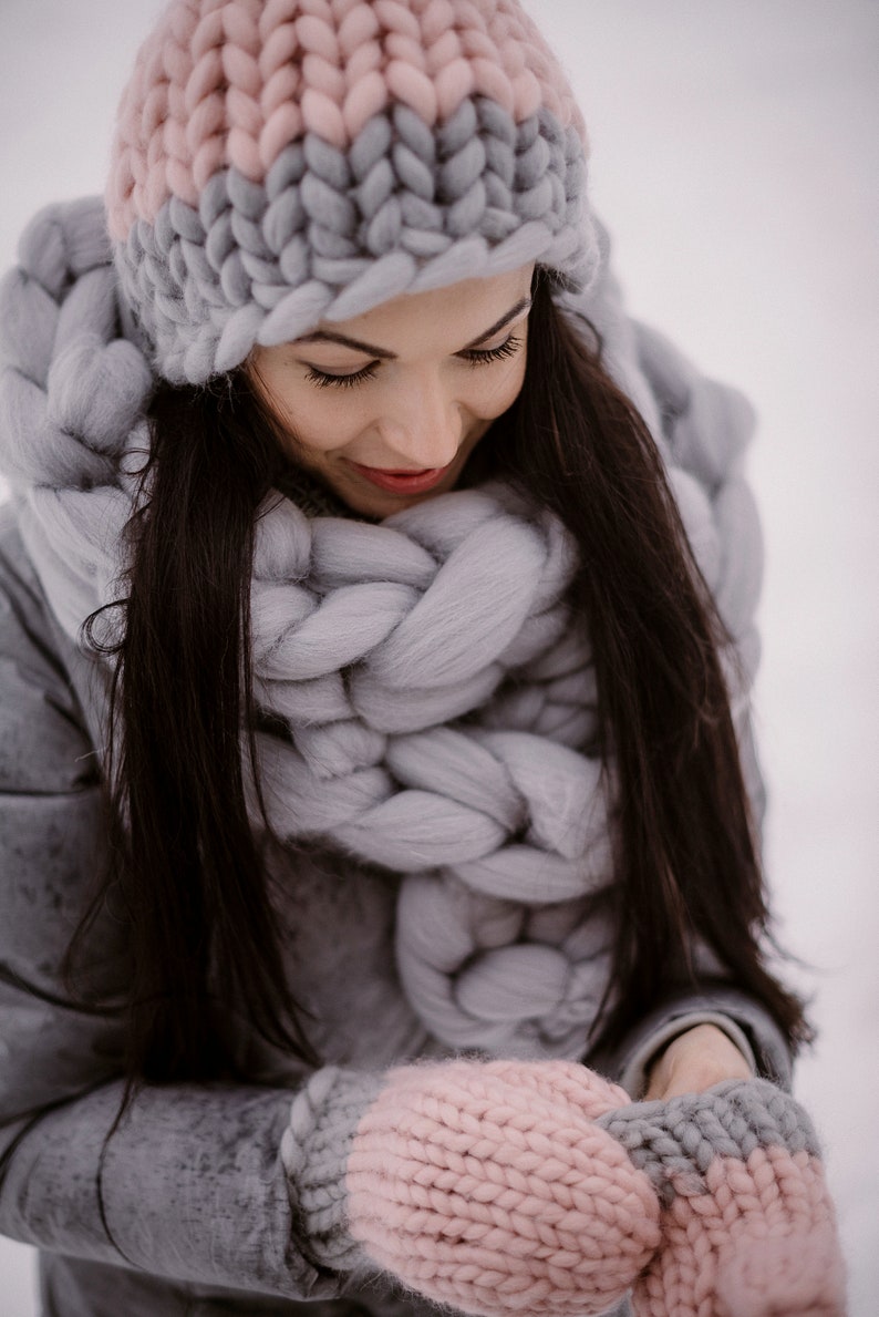 Lady outdoors with chunky scarf and had in winter