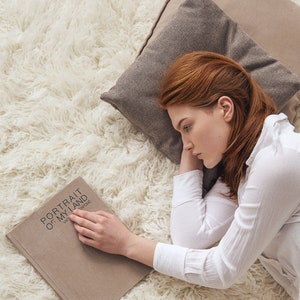 girl reading book and the floor on a cozy and fluffy shaggy rug