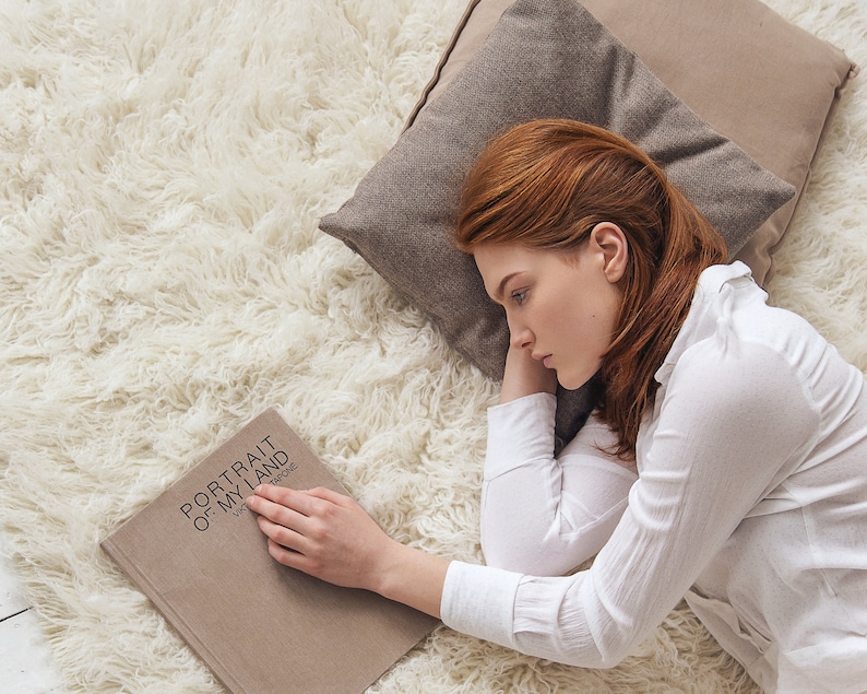 girl reading book and the floor on a cozy and fluffy shaggy rug