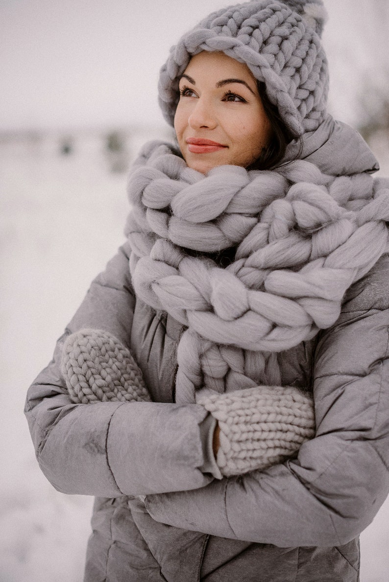 lady wearing set of chunky scarf hat and mittens in gray