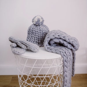 set of gray super chunky knit scarf mittens and pom pom beanie