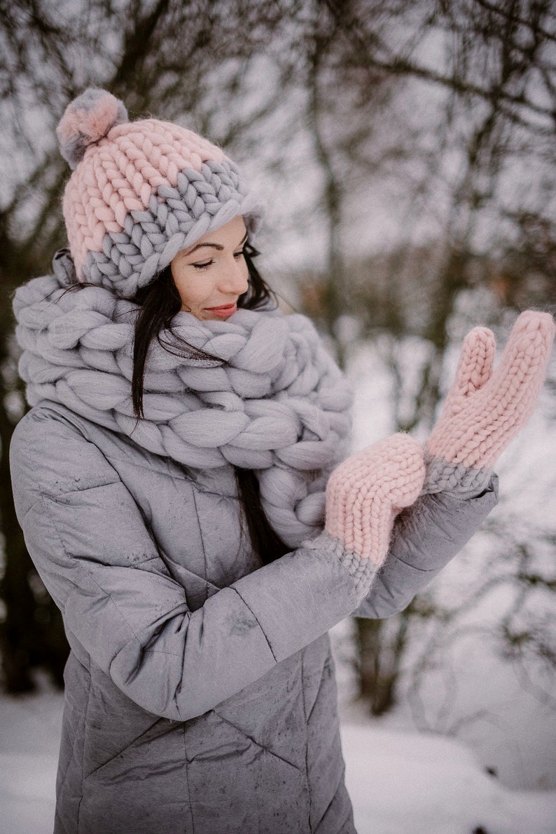 lady wearing a set of chunky knit scarf mittens and hat outside in winter