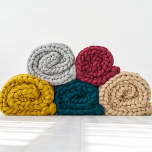 Giant chunky knit blankets in mustard, teal, beige, burgundy and grey