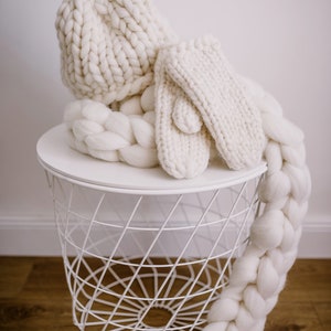 white set of bulky and fluffy chunky knit scarf gloves and pom pom hat