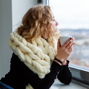 Girl at the window in white fluffy chunky scarf in white