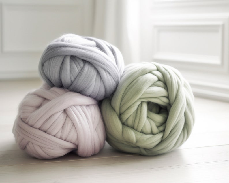 merino wool jumbo yarn balls in pastel colors on the floor