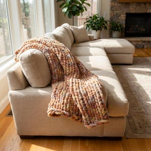 Op de afbeelding: Een witte keramische mok met een zwart handvat en de tekst "But First, Coffee" in een zwarte, handgeschreven lettertype. De mok staat op een wit oppervlak.