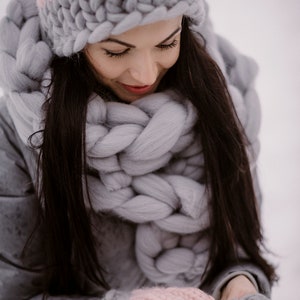lady wearing chunky huge scarf with mittens and hat outside in winter