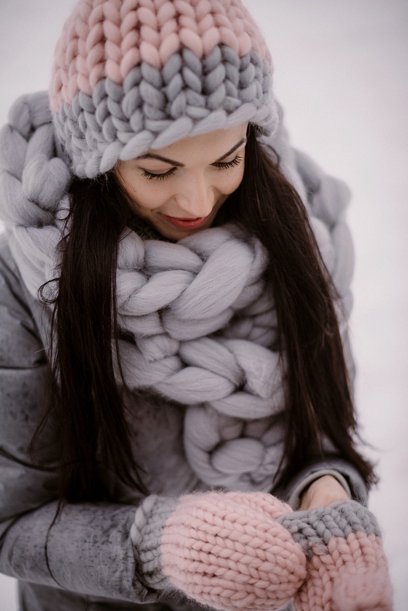 lady wearing chunky huge scarf with mittens and hat outside in winter