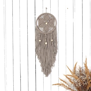 wall hanging in taupe on the white wall made of 3mm macrame cotton rope