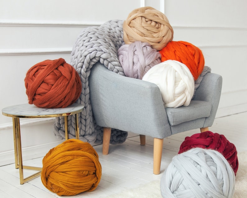 Lots of chunky merino wool yarn balls ready for arm knitting