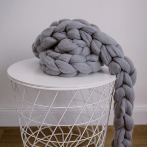 Chunky knit scarf in grey on the coffee table