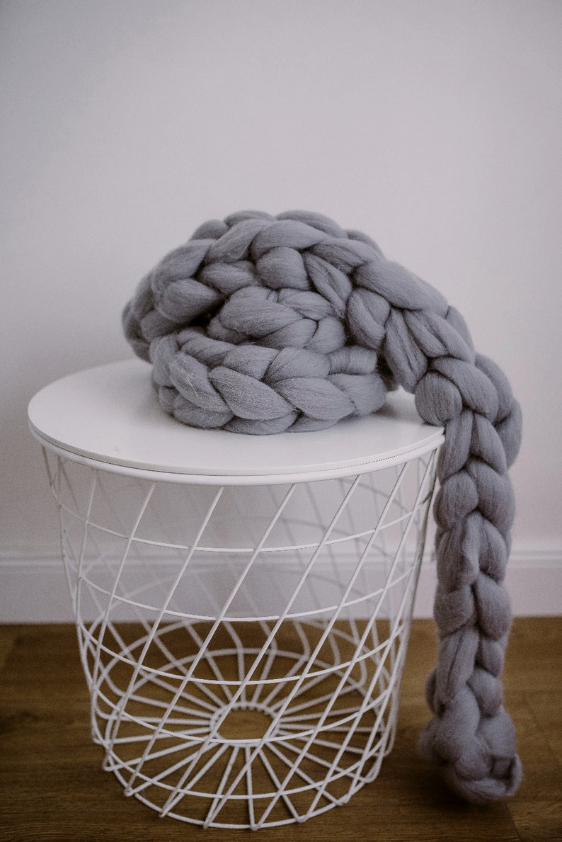 Chunky knit scarf in grey on the coffee table