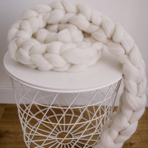 White chunky scarf made of merino wool on the table