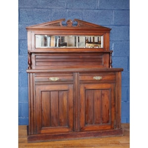 A Victorian Carved Walnut Chiffonier with Mirrored Back