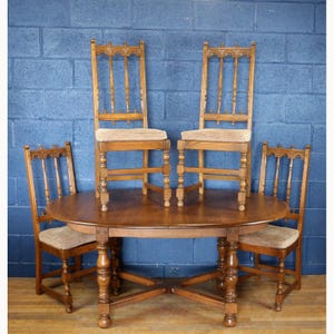 An Ercol Old Colonial Extending Dining Table & Set of Four Ercol Gothic Old Colonial Chairs