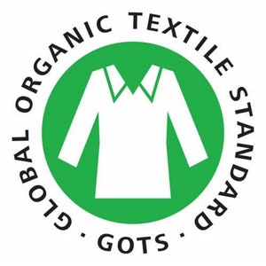 May include: A green circle with the text "GLOBAL ORGANIC TEXTILE STANDARD - GOTS -" around the outside. Inside the circle is a white silhouette of a shirt.
