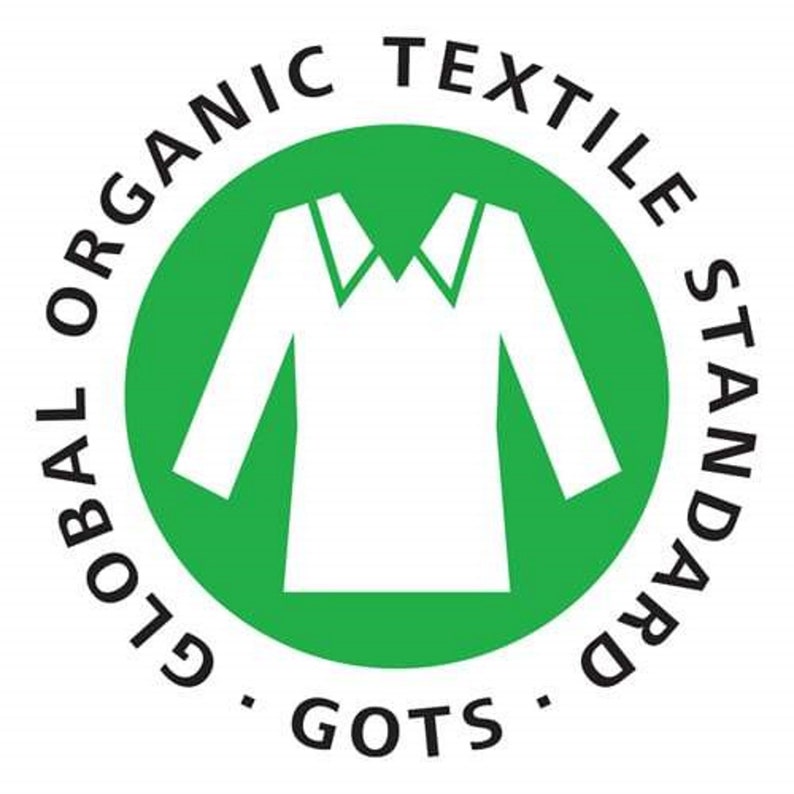 May include: A green circle with the text "GLOBAL ORGANIC TEXTILE STANDARD - GOTS -" around the outside. Inside the circle is a white silhouette of a shirt.