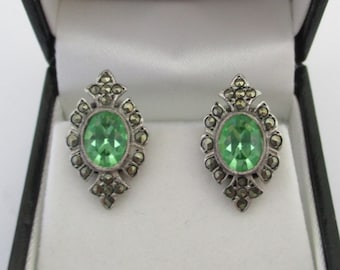 A pair of sterling silver marcasite earrings with green stones mid 20th century 6.01 grams