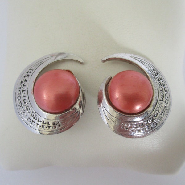 A vintage 1980's pair of SEVA silver metal curl shaped clip on earrings